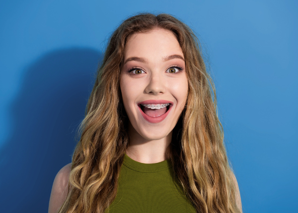 Excited teenage girl smiling widely to show off her traditional braces at Delta Smiles in Antioch and Brentwood, CA